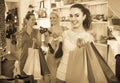 Three girls holding a paper shopping bags in the boutique Royalty Free Stock Photo