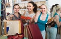 Three girls holding a paper shopping bags in the boutique Royalty Free Stock Photo