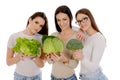 Three girls holding savoy, lettuce and broccoli
