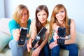 Three girls with mobile phones Royalty Free Stock Photo