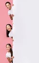 Three Girls Peeking Out Of Blank Board Posing, Pink Background Royalty Free Stock Photo