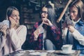 Three girls playing card in cafe. Royalty Free Stock Photo