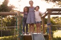 Three Girls Playing Outdoors At Home On Garden Slide Royalty Free Stock Photo
