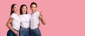 Three Girls Pointing Finger Looking Aside Standing Over Pink Background Royalty Free Stock Photo