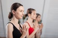 Three girls practicing yoga. Yoga instructor with her students meditating in a studio Royalty Free Stock Photo