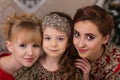 Three girls in a red evening dress the Christmas tree. Royalty Free Stock Photo