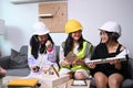 Three girls in safety helmet pretend to be engineer.