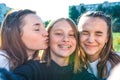 Three girls schoolgirls 13-15 years old, autumn summer day city, selfies photographed, happy smiling laughing, casual Royalty Free Stock Photo