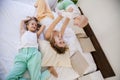 Three girls sisters in the morning in the bedroom on the bed play Royalty Free Stock Photo