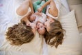 Three girls sisters in the morning in the bedroom on the bed play Royalty Free Stock Photo