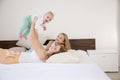 Three girls sisters in the play in the bedroom in the morning love Royalty Free Stock Photo