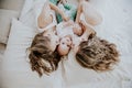 Three girls sisters in the play in the bedroom in the morning love Royalty Free Stock Photo
