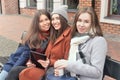 Three girls sit on the bench outdoors Royalty Free Stock Photo