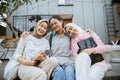 three girls sitting and smiling at the camera Royalty Free Stock Photo