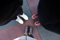 Three girls in skates stand on the street in winter, skating, top-down view, three of us on the road in skates Royalty Free Stock Photo