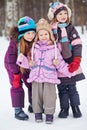 Three girls stand together in winter park Royalty Free Stock Photo