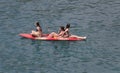 Girls on a sea kayak in La Calobra beach in the north coast of the island of Mallorca wide