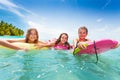 Three girls swim in the sea on surfboards Royalty Free Stock Photo