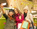 Three girls taking selfie in the city after shopping