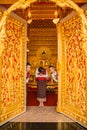 Three girls welcoming tourist to Buddhist church.