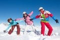 Family ski trip. Three girls on winter holidays in the Alps posing in the snow on the ski slopes