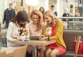 Three gladsome women in the coffee shop Royalty Free Stock Photo