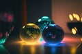 three glass balls sitting on a table with a light shining on them and a vase in the background with a candle Royalty Free Stock Photo