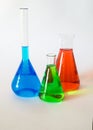 Three glass beakers filled with coloured liquid. Royalty Free Stock Photo