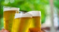 three glass of beer in hand. Beer glasses clinking at outdoor bar or pub Royalty Free Stock Photo