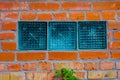 Three Glass Blocks With Pattern Walled inside The Brick Wall. Building Facade With Damaged Royalty Free Stock Photo