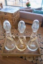 Three glass bottle on wood tray