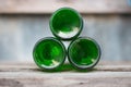 Three glass bottles, green bottoms lie ahead on wooden Royalty Free Stock Photo