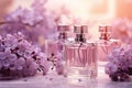 Three glass bottles of perfume surrounded by violet flowers on a light blurred background Royalty Free Stock Photo