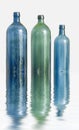 Three glass bottles on white surface with water effect. Old colorful vintage wine bottles arranged against a copy space Royalty Free Stock Photo