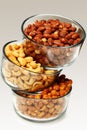 Three glass bowls filled with cashews, salted roasted almonds an Royalty Free Stock Photo