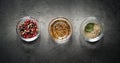 Three glass bowls with herbs and spices