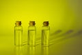 Three glass corked bottles filled with liquid. Background for science and medicine. Virus vaccine Royalty Free Stock Photo