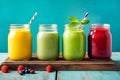 Three glass jars with colorful red yellow green smoothie from vegetables fruits berries. Healthy plant based diet detox vitamins Royalty Free Stock Photo