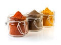 Three glass jars filled with spices