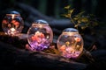 three glass jars with flowers in them on a log Royalty Free Stock Photo