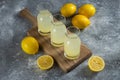 Three glass jugs of cold lemonade on a wooden board Royalty Free Stock Photo