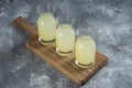 Three glass jugs of fresh lemonade on a wooden board Royalty Free Stock Photo