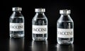 Three glass vaccine vials on black board, closeup detail Royalty Free Stock Photo