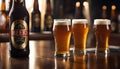 Three glasses of beer on a bar counter with a beer bottle in the background Royalty Free Stock Photo