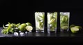 Three glasses of cocktail mojito lemonade on the bar. Party cocktail. Lime, ice and mint on the table. Black background.