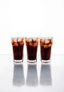 Three glasses of cola and ice on a white background. soft drinks Royalty Free Stock Photo