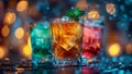 Three glasses containing different colored drinks placed on a table. Royalty Free Stock Photo