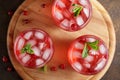 Three glasses with cranberry cold summer drink on the wooden cutting board. Royalty Free Stock Photo