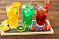 Three glasses of different cold summer drinks or refreshing cocktails yellow, green, red in toxic colors. Royalty Free Stock Photo