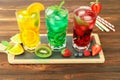 Three glasses of different cold summer drinks or refreshing cocktails yellow, green, red in toxic colors. Royalty Free Stock Photo